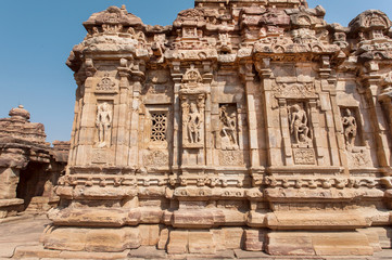 Walls with Indian design of stone relief on 7th century temples in Pattadakal of Karnataka, India....