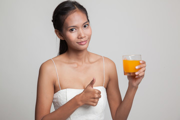 Young Asian woman thumbs up drink orange juice.