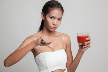 Asian woman thumbs down  hate tomato juice.