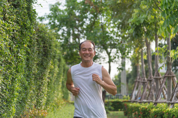 Naklejka na ściany i meble old man exercise by jogging at the park, health concept