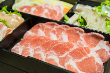Uncooked raw fresh pork slices for Sukiyaki. Isolated on white background.