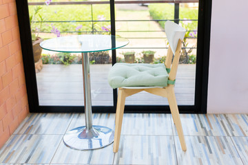 Table and chairs are placed by the window.