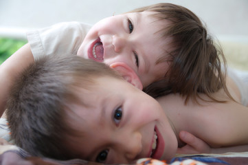 kids laughing happy children smiling portrait playing together siblings little girl and boy brother and sister toddlers having funchildhood friendship. Funny two kids faces cute and carefree