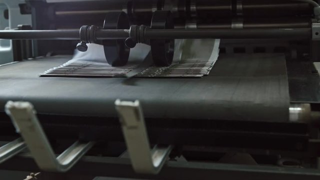 Printing Process on polygraph industry - brochures moving on the conveyor belt, slider