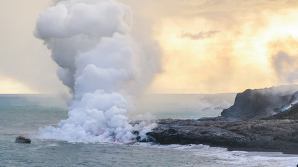 Fototapeta na wymiar Amazing view of lava pouring into the sea in Volcanoes National Park, Big Island, Hawaii