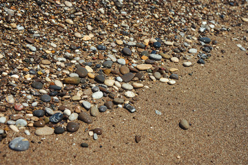Close up of a pebble beach with the sea.