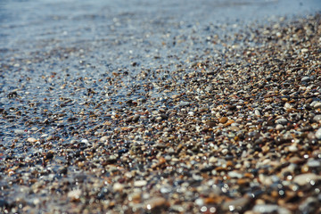 Close up of a pebble beach with the sea.