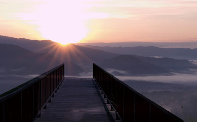 Fototapeta premium Panoramic view of a mountain in autumn with a foggy at sunrise