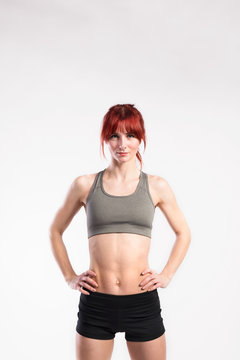 Attractive young fitness woman in sports bra. Studio shot.