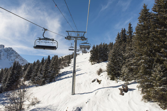 Panoramic view of an alpine mountainside with ski lift