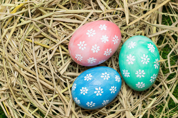 Easter eggs on straw background