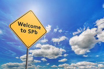 Blue cloudy sky and yellow road sign