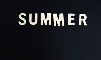 summer word wood text on Blackboard and black background