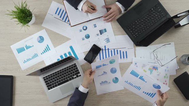 Analysts studying opinion poll statistics, preparing election campaign strategy