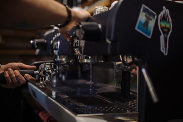 barista is making coffee on coffee machine
