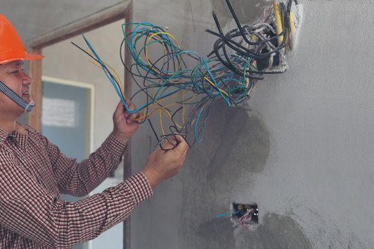 Electricians clears the ends of the wires. installation works