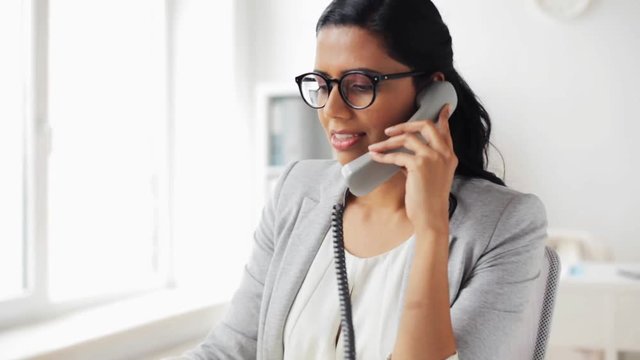 businesswoman calling on phone at office