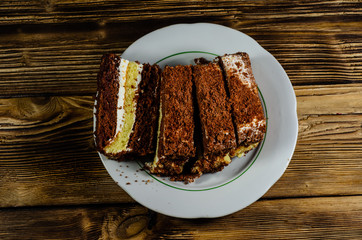 Sliced biscuit cake in plate. Top view