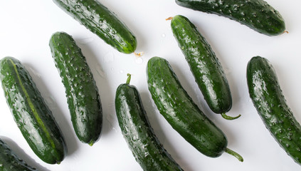 Fresh cucumbers on white wooden table