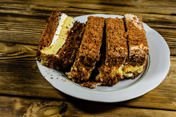 Biscuit cake in plastic container on wooden table