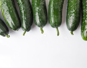 Freshly washed cucumbers on a wooden table