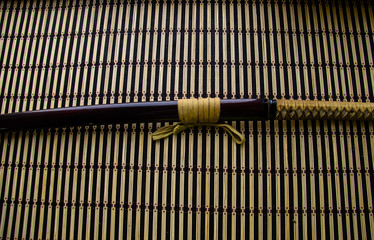 Japanese sword katana on bamboo mat