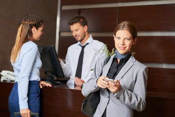 Businesswoman at check-in in hotel