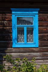 Old European wooden window with shutters and flower