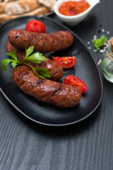 Fried sausages with herbs in a pan
