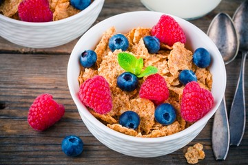 Healthy breakfast: whole grain cereal with raspberry and blueberry