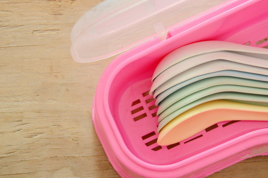 colorful plastic soup spoon in pink box