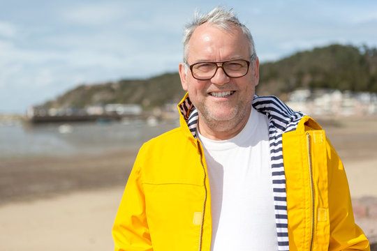 Portrait Of A Senior Attractive Fisherman On A Dock