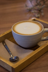 A cup of hot capuchino coffee