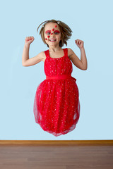 Naklejka premium Little girl with ladybug face paint jumping