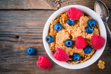 Healthy breakfast: whole grain cereal with raspberry and blueberry