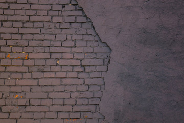 The old plaster on gray brick wall