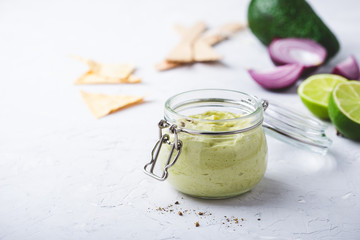 Homemade creamy avocado salsa with greek yogurt in jar