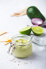 Homemade creamy avocado salsa with greek yogurt in jar