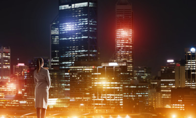 Woman looking at night city