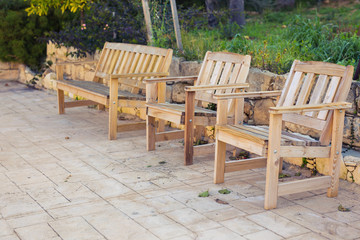 White outdoor furniture. Lounge chairs in hotel garden invite you to relax