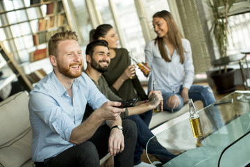 Group of male and female friends having fun at home