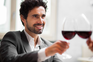 Couple toasting wineglasses in a restaurant