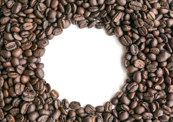 Coffee beans are arranged in a circle image with copy space.