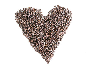 Coffee beans are arranged in a heart image with copy space.