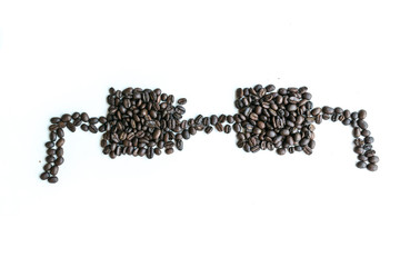 Coffee beans are arranged in a eyeglasses image with copy space.