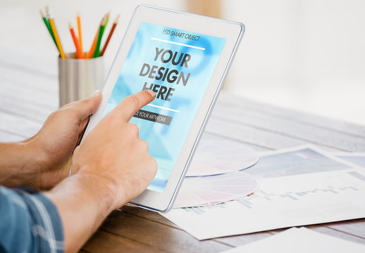 User at Wooden Desk with Tablet Mockup 2