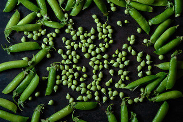 Hearthy fresh green peas and pods on rustic background