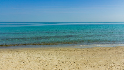 Fototapeta na wymiar Clear sky and sea landscape. Hot sea summer shot on a sandy beach