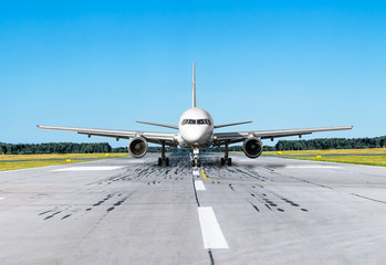 Plane on the runway asphalt road and blue sky