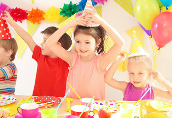 Cute little children celebrating birthday at party